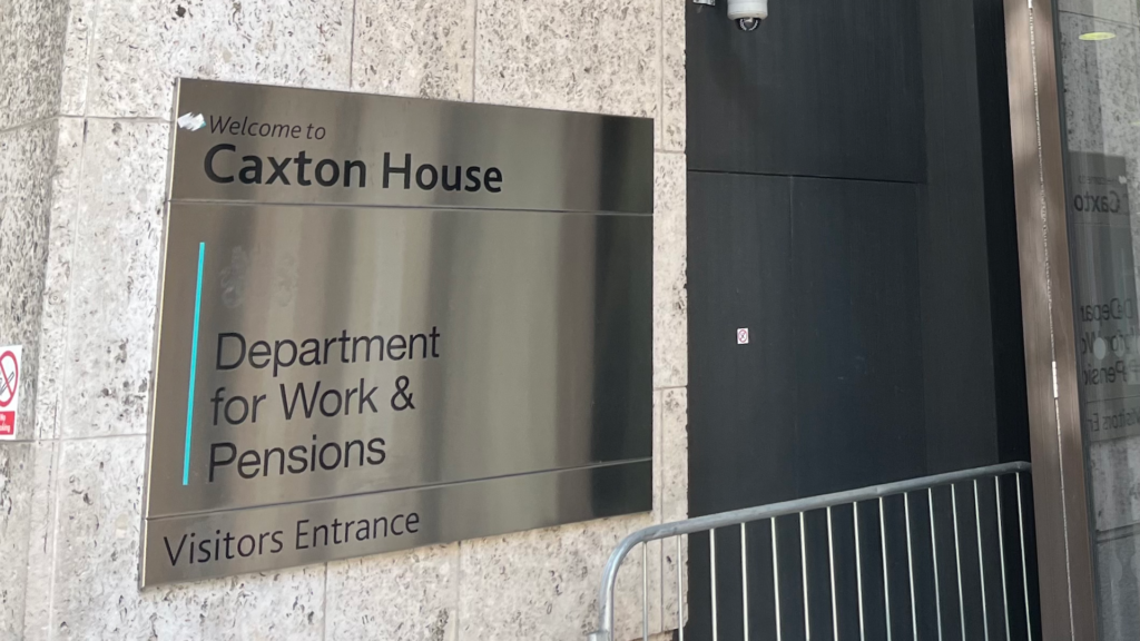 DWP May Cut Benefit Payments by 15% in Some Cases — Here's Who Could Be Affected 2 Entry Sign at Caxton House, DWP Office